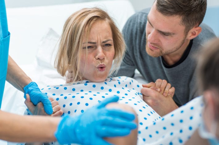 Pregnant woman in labour - pushing - benefits of exercise in pregnancy