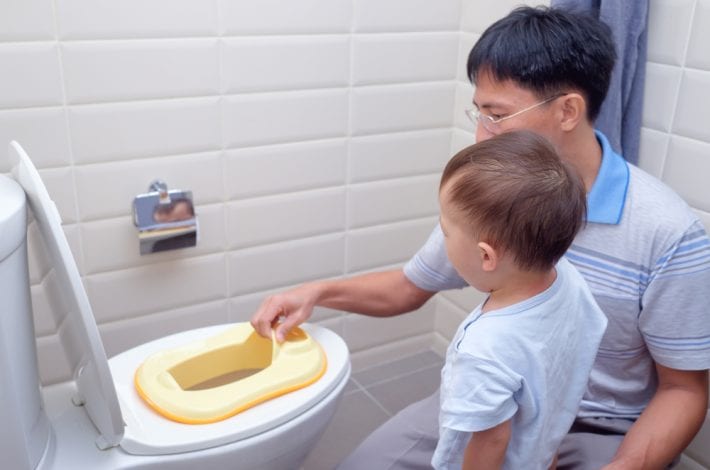 potty training - father talking to son about toilet