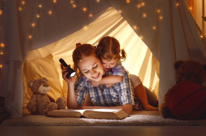 mother reading to toddler in a magic tent - fun ways to learn letters