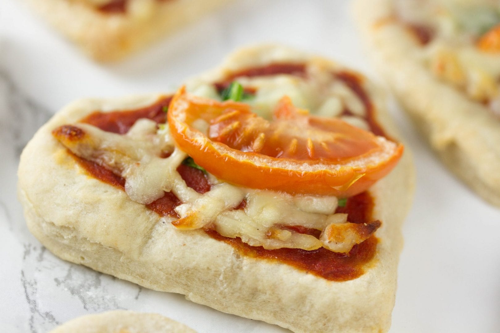 Pizza hearts - try this fun Valentines recipe for kids with these mini pizzas