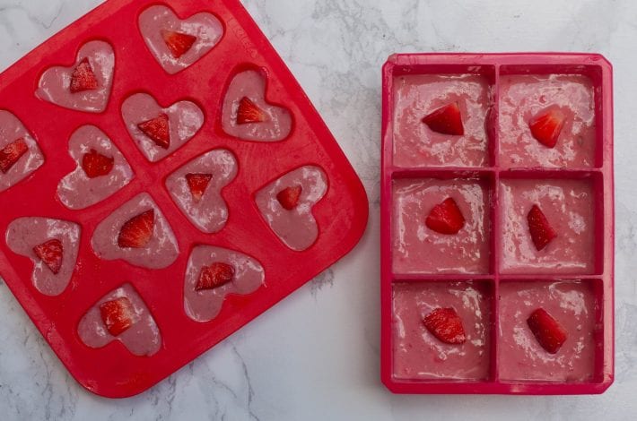 Frozen fruit chew bites made with fresh strawberries and peanut butter and frozen into bars for kids snacks