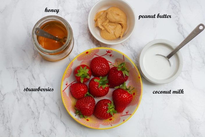 Frozen fruit chew bites made with fresh strawberries and peanut butter and frozen into bars for kids snacks